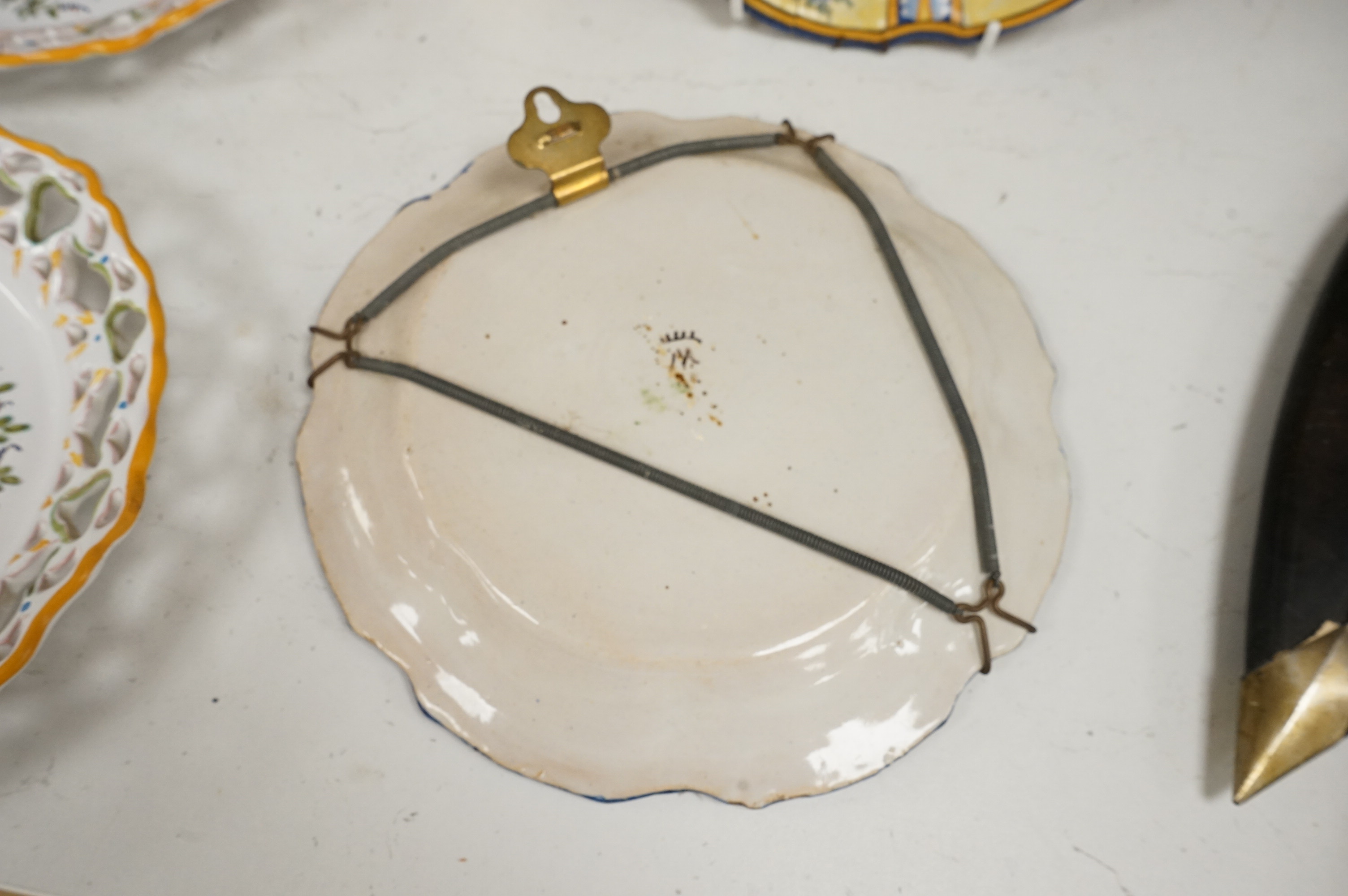 A Delft charger after Artz, together with other faience and majolica dishes, largest 41cm diameter (6)